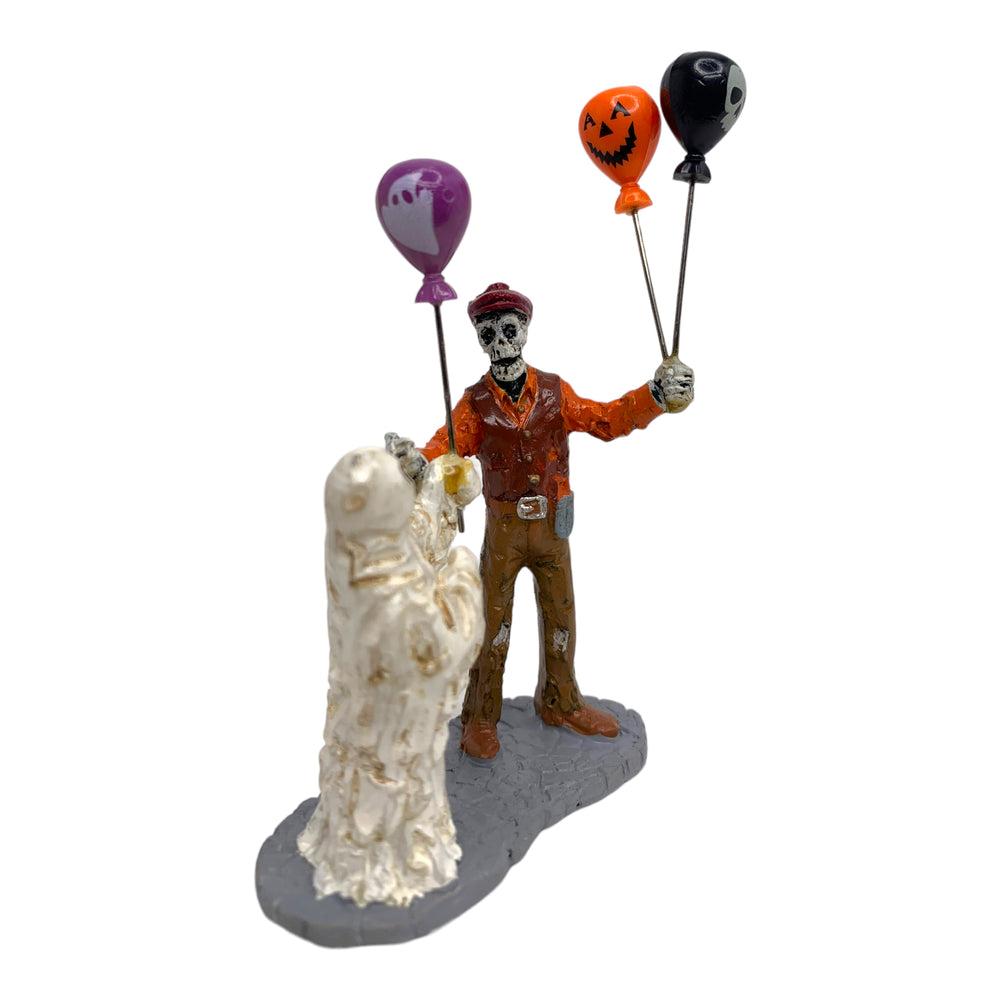 Retired Lemax Spooky Town Boolloon Seller #02800 - A skeleton sells Halloween themed balloons to a ghost.
