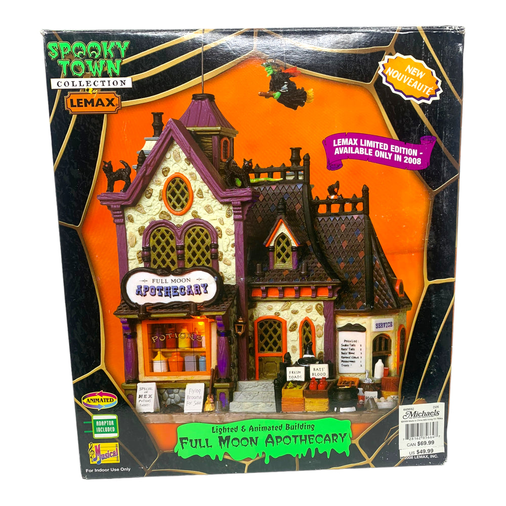 Retired Lemax Spooky Town Full Moon Apothecary #85664 - A witch flys over a purple and orange cottage shop.