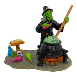 Retired Lemax Spooky Town The Witch's Cauldron #42840 - a green witch mixes potions into a bubbling cauldron.