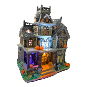 Retired Lemax Spooky Town Dreadful Manor #85708  - A dilapidated creepy mansions is covered in jack o lanterns, tombstones and skeletons.