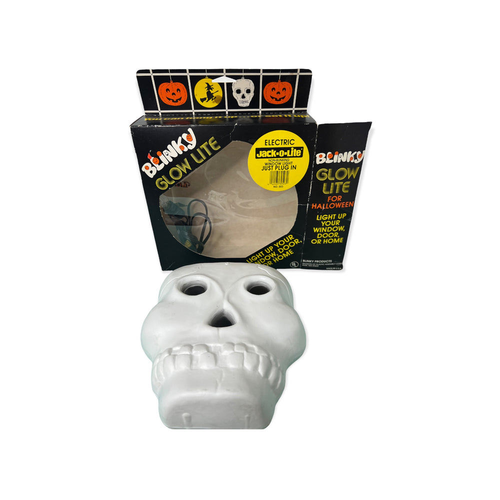 
            
                Load image into Gallery viewer, A blow mold skull in a 1990s blinky Glow lite box
            
        