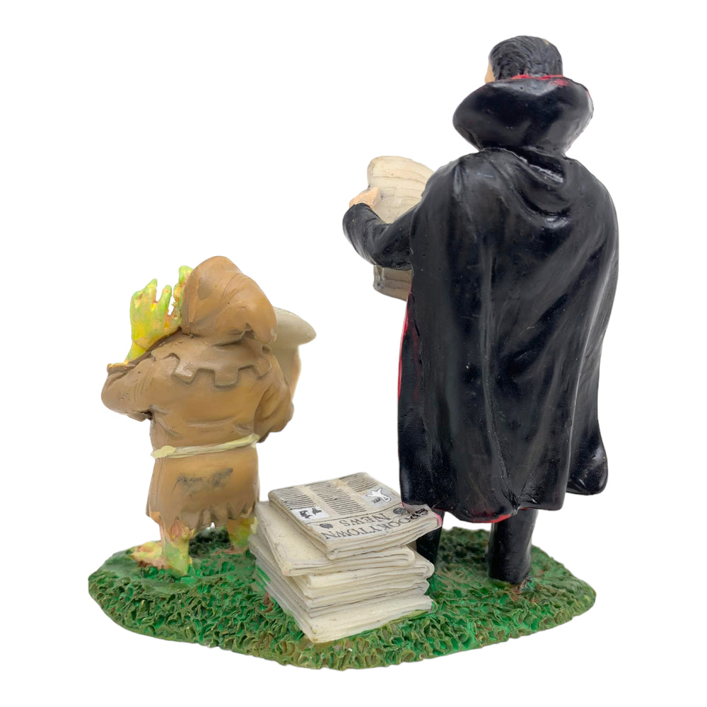 Retired Lemax Spooky Town Halloween Edition #72369 - a vampire and a ghoul stand next to each other and sell spooky papers.